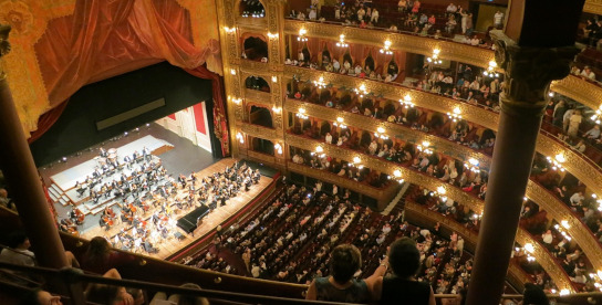 Theatersaal mit Bühne und Publikum auf den Rängen